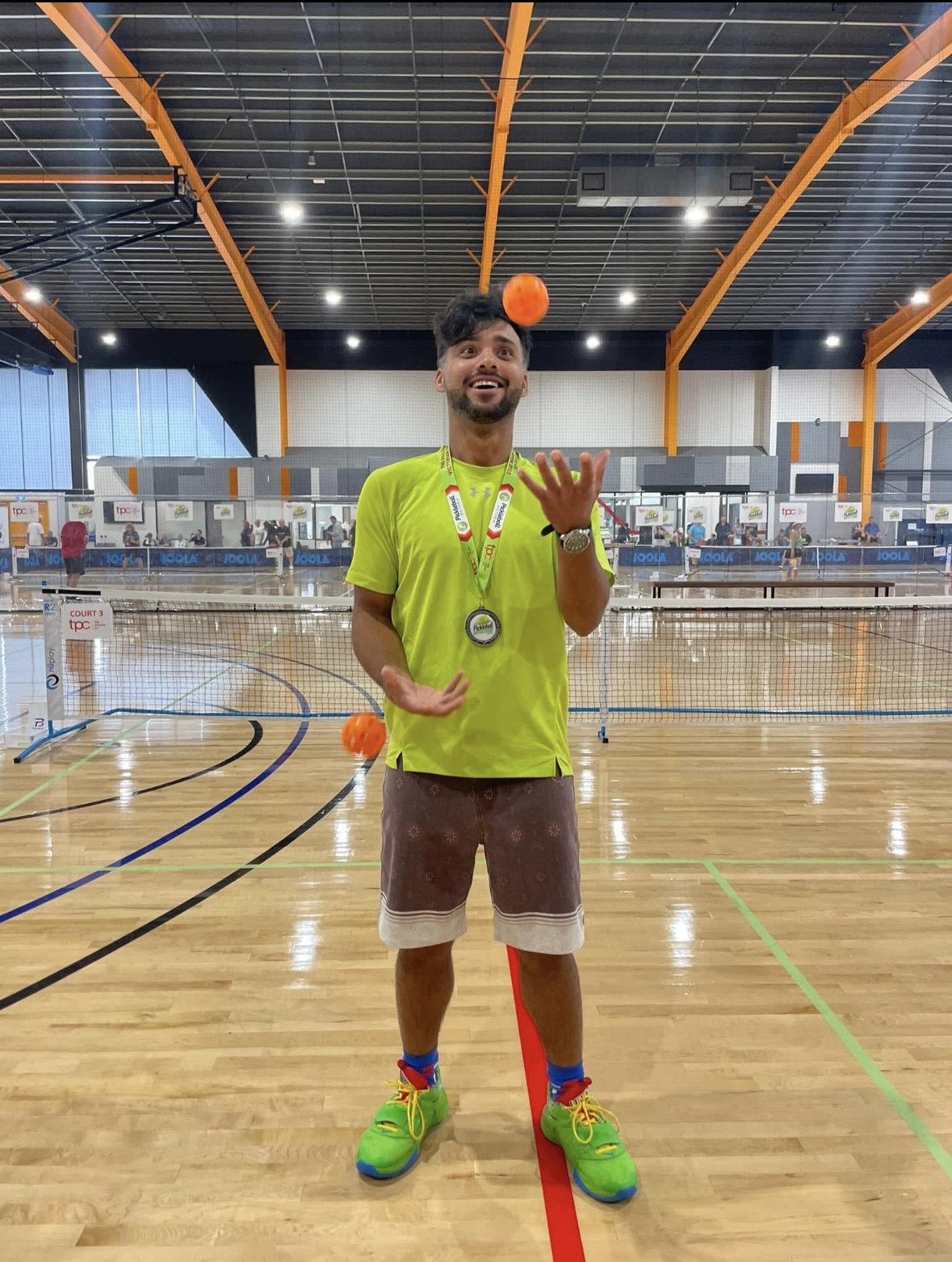 Sueme Rajpal juggling pickleballs at an Australian pickleball tournament.
